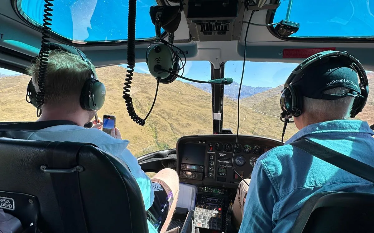 The view from a helicopter cockpit over a mountain range near Queenstown
