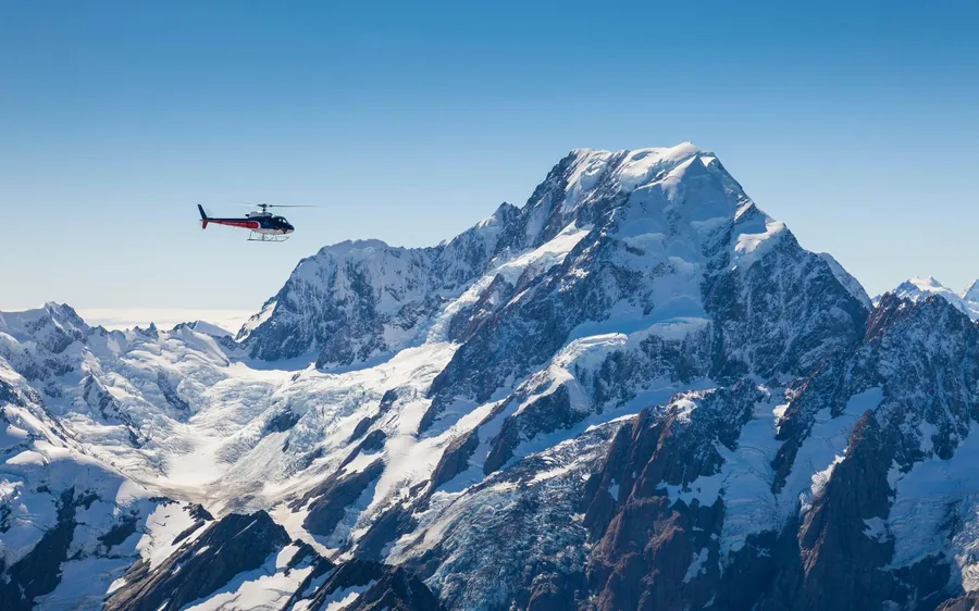 Mountains and a fiord at the end of the day seen from a helicopter window